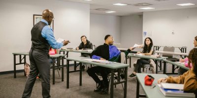 University classroom with students receiving instructions from a professor.